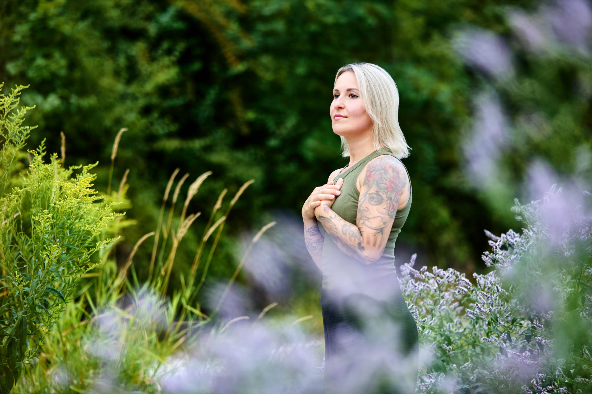 Elwira Schechinger im Garten zwischen Gräsern und Blüten